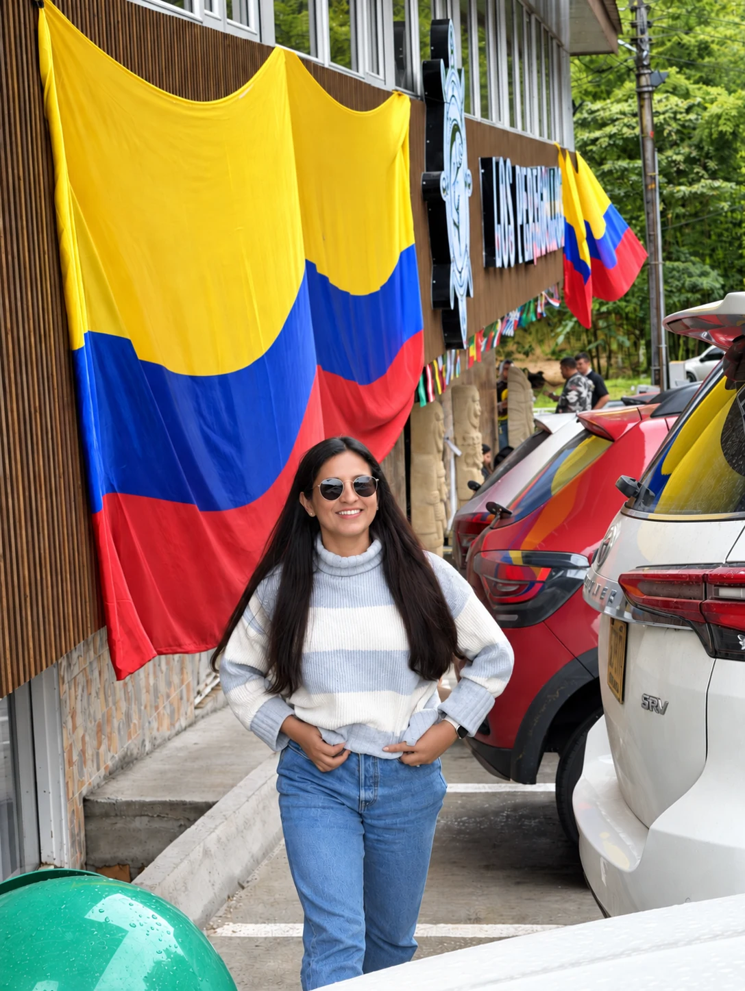 Ara en Colombia frente a banderas colombianas